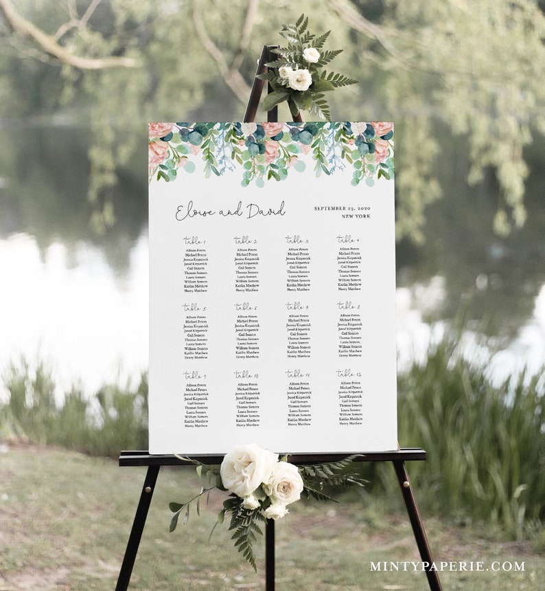 May include: A wedding seating chart with a floral design. The chart is on an easel and lists the names of guests and their assigned tables. The text on the chart reads "Eloise and David" and "September 11, 2019, New York".