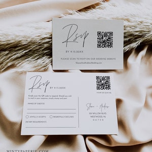 May include: A white RSVP card with a black and white QR code. The card has the text "RSVP" in a script font and the date "BY 9.15.20XX". The card also has the text "PLEASE SCAN TO RSVP ON OUR WEDDING WEBSITE SloaneAndAndrewWedding.com".