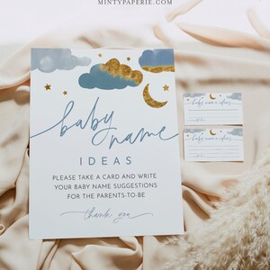 May include: A white card with blue and gold watercolor clouds, stars, and a crescent moon. The text reads "baby name ideas" and "Please take a card and write your baby name suggestions for the parents-to-be. Thank you."
