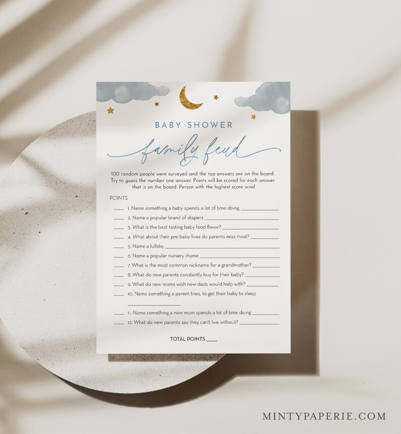 May include: A printable baby shower game with a blue and gold color scheme. The game is called "Family Feud" and asks players to guess the top answers to questions about babies and new parents. The game includes a section for points and a total points section.