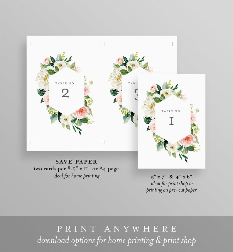 May include: Two printable table number cards with floral designs. The cards feature a hexagonal frame with the table number in the center. The floral design includes white and pink flowers with green leaves. The text on the cards reads "Table No. 2" and "Table No. I".