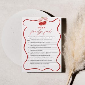 May include: A printable baby shower game with a red and white cherry design. The game is called "Baby Family Feud" and asks players to guess the top answers to questions about babies.