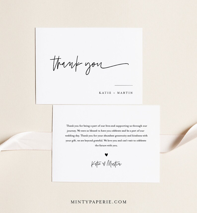 May include: A white thank you card with black text. The card says "Thank you" in cursive and "Katie Martin" in a simple font. The card also includes a smaller card with a thank you message and the couple's names in cursive.