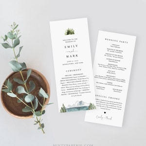 May include: Wedding ceremony program with a watercolor illustration of mountains and a lake. The program includes the names Emily and Mark, the date June 27, 2020, and the location Middletown, New York. The program also includes a list of the wedding party members and their roles.