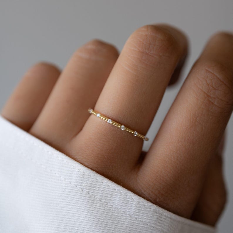 Thin gold ring on model