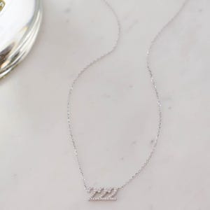 Diamond-studded 222 minimalist necklace, ideal for layering or wearing solo.