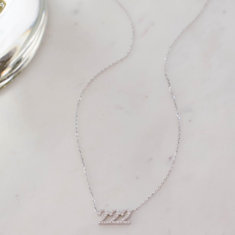 Diamond-studded 222 minimalist necklace, ideal for layering or wearing solo.