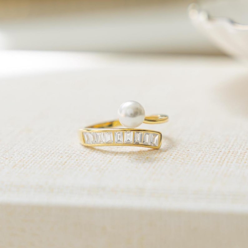 Freshwater pearl ring intertwined with gold baguette wrap ring