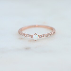 rose gold ring featuring lab created opal with cubic zirconia stones