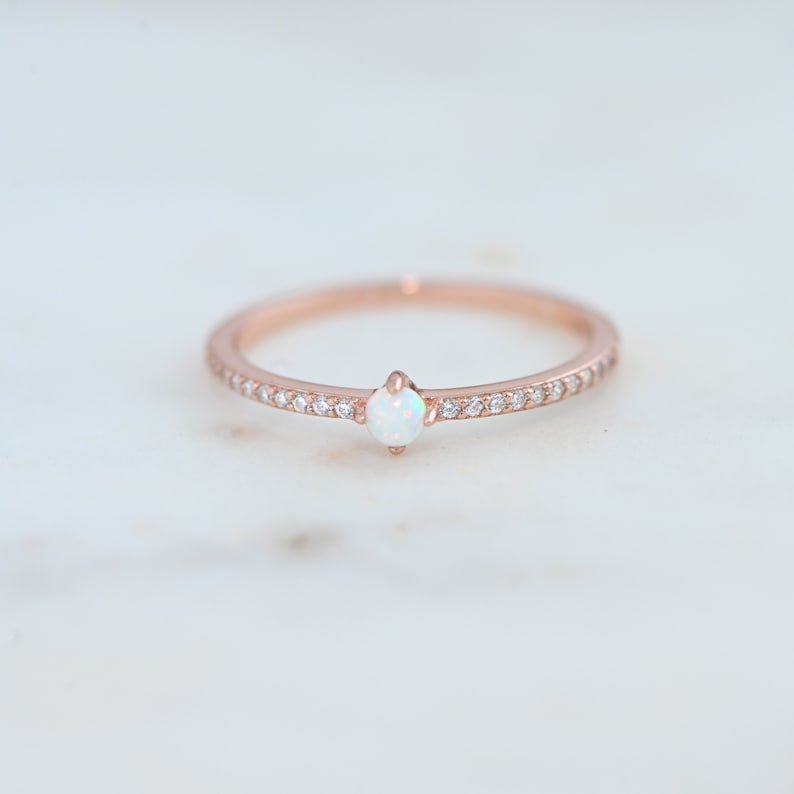rose gold ring featuring lab created opal with cubic zirconia stones