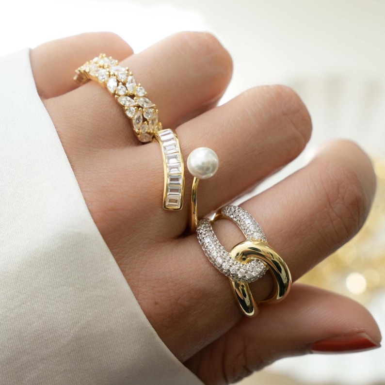 Model wearing unique rings featuring freshwater pearl wrap ring with 14k gold plating