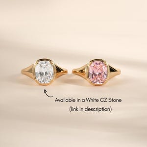 Elongated cushion cut gemstone rings shown in the pink stone colorway alongside the white CZ stone option.