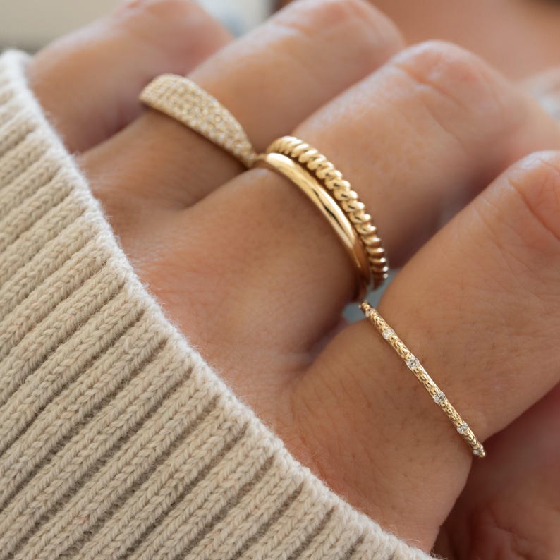 Model wearing gold ring stack