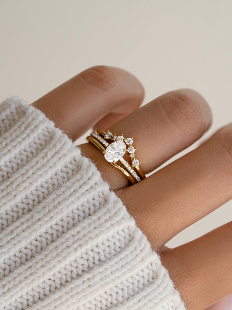 Gold oval engagement ring set on model