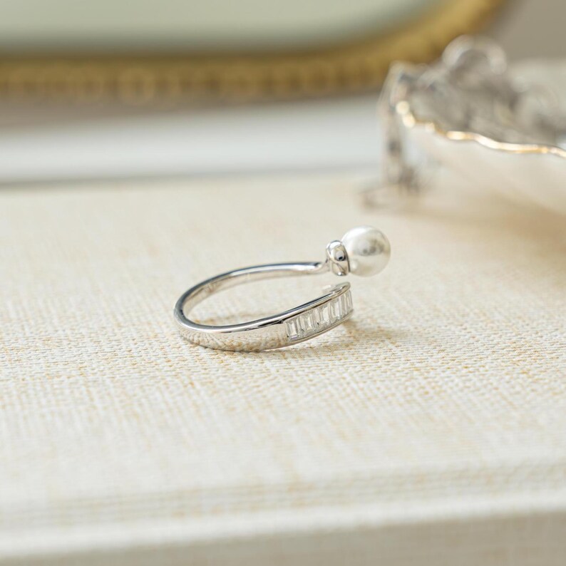 side closeup view of  sterling silver baguette ring with wrap ring design