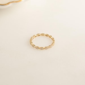 Flatlay of gold eternity band