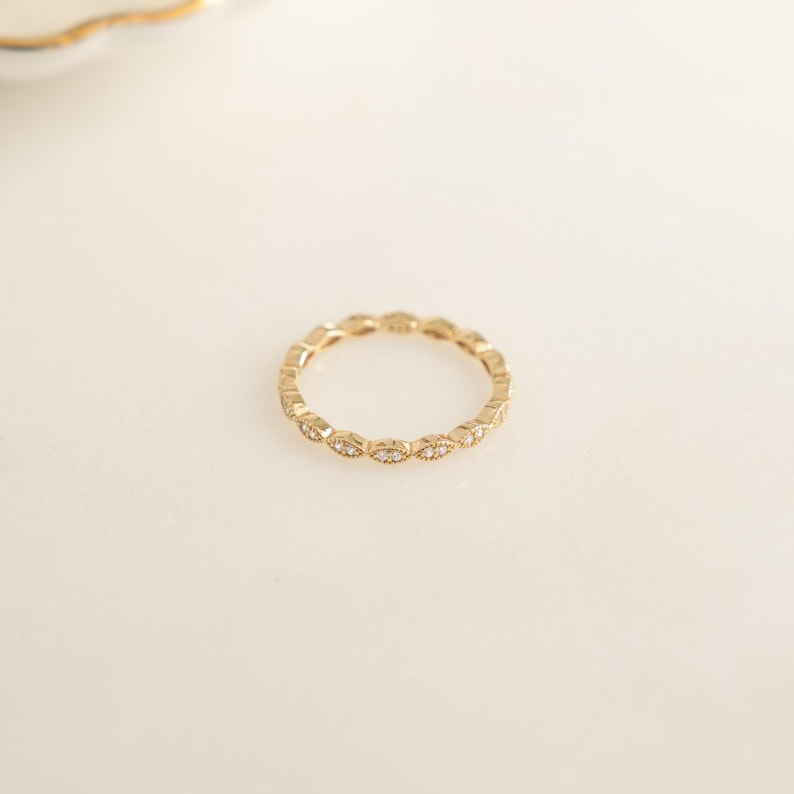 Flatlay of gold eternity band