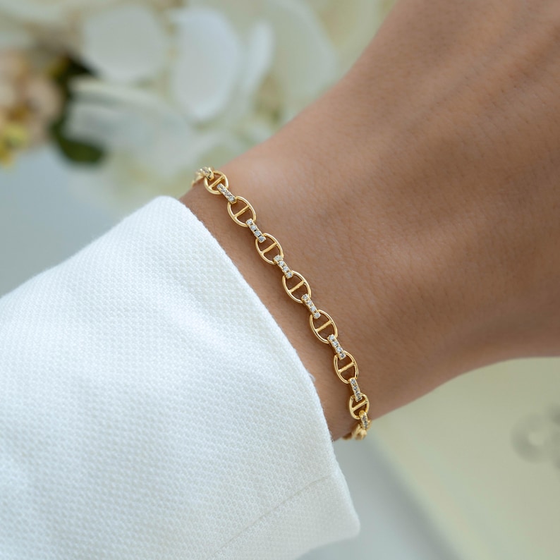 model wearing a gold chain bracelet