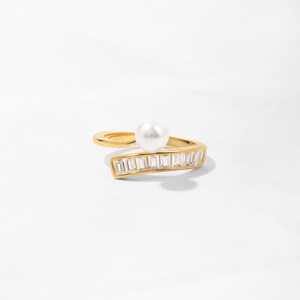 14k gold plated ring featuring a gold wrap design, accented with freshwater pearls and baguette-cut diamonds