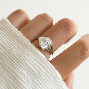 Elongated cushion cut ring in sterling silver, shown worn on the hand with a bezel setting for a vintage-inspired statement look