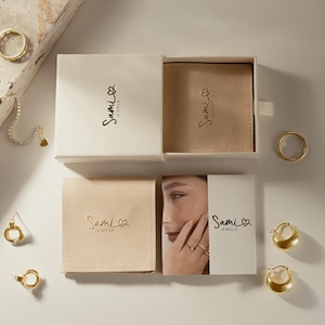 a box containing a ring and a ring box with a picture of a woman