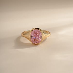Elongated pink solitaire cz ring in gold front view