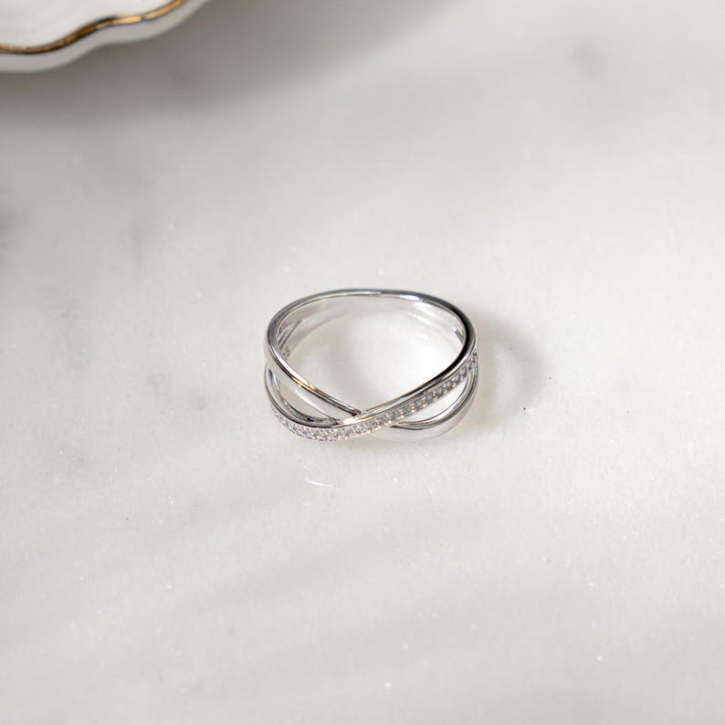 close up of diamond X ring in a flat lay