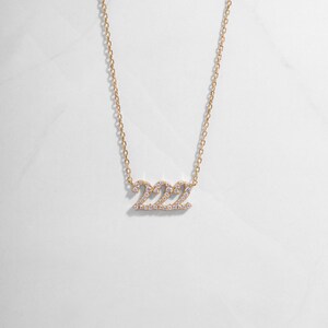 Gold 222 positive affirmation necklace with a dainty studded design