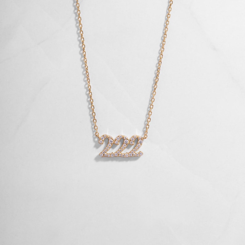 Gold 222 positive affirmation necklace with a dainty studded design
