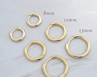 May include: Five gold hoop earrings of different sizes, 8mm, 11mm, and 13mm.