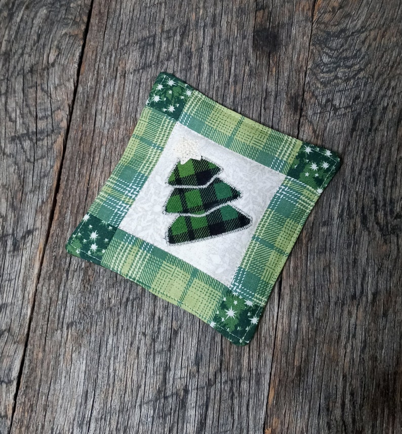 Hand made coasters with country Christmas charm sold in sets of 4. Quilted Christmas coasters with appliqued Christmas tree and star