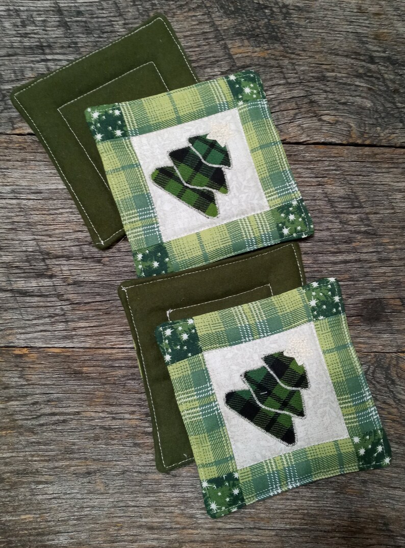 Hand made coasters with country Christmas charm sold in sets of 4. Quilted Christmas coasters with appliqued Christmas tree and star
