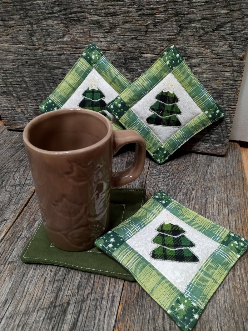 Hand made coasters with country Christmas charm sold in sets of 4. Quilted Christmas coasters with appliqued Christmas tree and star