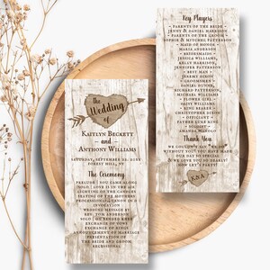 May include: Two vertical wedding program cards with a light wood grain background. The left card features a heart with an arrow and the text The Wedding of Kaitlyn Beckett and Anthony Williams. The right card lists Key Players and a Thank You message.