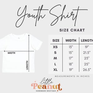 May include: Youth shirt size chart with measurements in inches. XS: 13" wide, 19" long. S: 15" wide, 21.5" long. M: 17" wide, 23" long. L: 18" wide, 25" long. XL: 19" wide, 26.5" long.