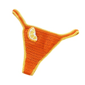 May include: Orange crochet bikini bottom with a crocheted orange slice detail.
