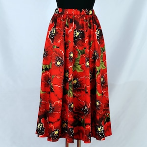 May include: A red midi skirt with a floral print of red poppies. The skirt has an elastic waistband and a flowing silhouette.