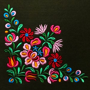 May include: Embroidered floral design on a black fabric background. The design features pink, red, orange, yellow, green, and blue flowers.