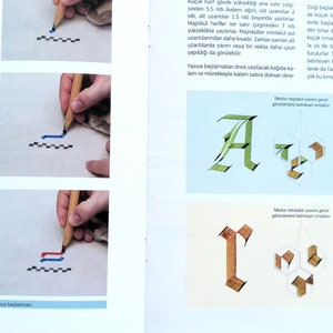 May include: A close-up of a calligraphy guide showing how to write the letters "A" and "r" using a grid system. The guide includes instructions on how to use a nib pen and create different strokes. The text in the image is in Turkish.