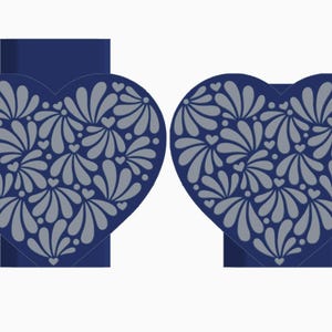 May include: Two navy blue heart-shaped decorations with gray floral patterns. The hearts have a stand at the bottom. The floral design includes petal shapes and small hearts. The background is white.