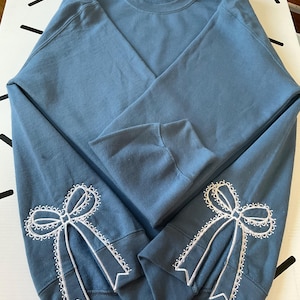 Embroidered Side Bow Sweatshirt: Classic Lace Design
