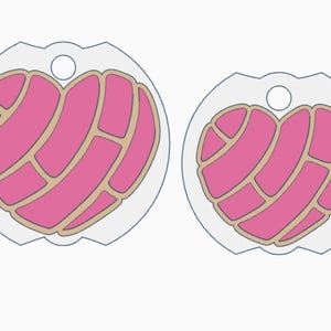 May include: Two pink heart-shaped pendants with a concha design, each with a light brown outline and a clear border. The pendants have a small hole at the top for hanging. The design is a vector illustration.