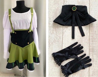 May include: A green and black skirt with a white blouse and black gloves. The skirt has a black waistband and a green and black plaid trim. The gloves have lace trim.