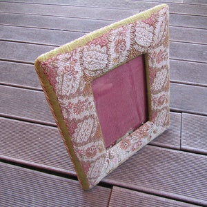 60s photo frame in upholstery fabric with floral decorations.