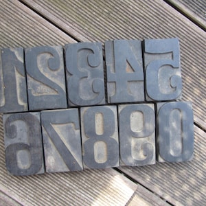 May include: A set of ten vintage wooden number blocks, painted black, with the numbers 1 through 10.