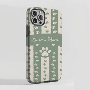 May include: A phone case with a green and cream striped design, adorned with paw prints and the text "Luna's Mom." The case has a large paw print and small hearts.
