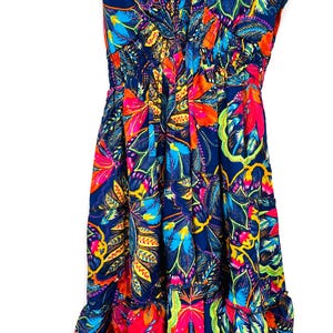 May include: A vibrant, sleeveless dress with a V-neckline and a flowing skirt. The dress features a colorful floral pattern in shades of blue, red, orange, and yellow. The fabric appears lightweight and suitable for warm weather.