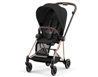 May include: Black stroller with a brown handle and accents. The stroller has a black canopy, seat, and wheels. The frame is rose gold. The stroller has a storage basket underneath the seat and a five-point harness.