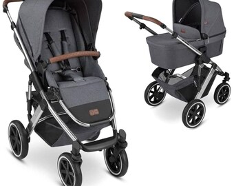 May include: A gray and black stroller with a brown handle and accents. The stroller has a canopy, a seat with a safety harness, and four wheels. The frame is silver. The stroller is shown in two configurations.