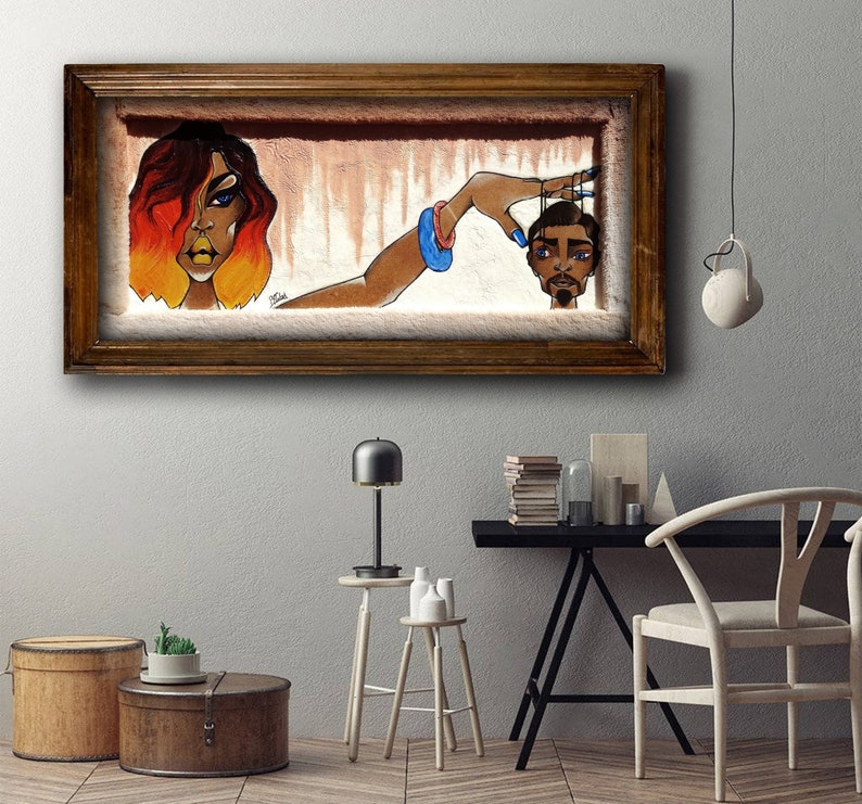 May include: A framed painting depicting a woman with orange hair holding strings attached to a man's head. The woman is wearing a blue bracelet and the man has a serious expression.